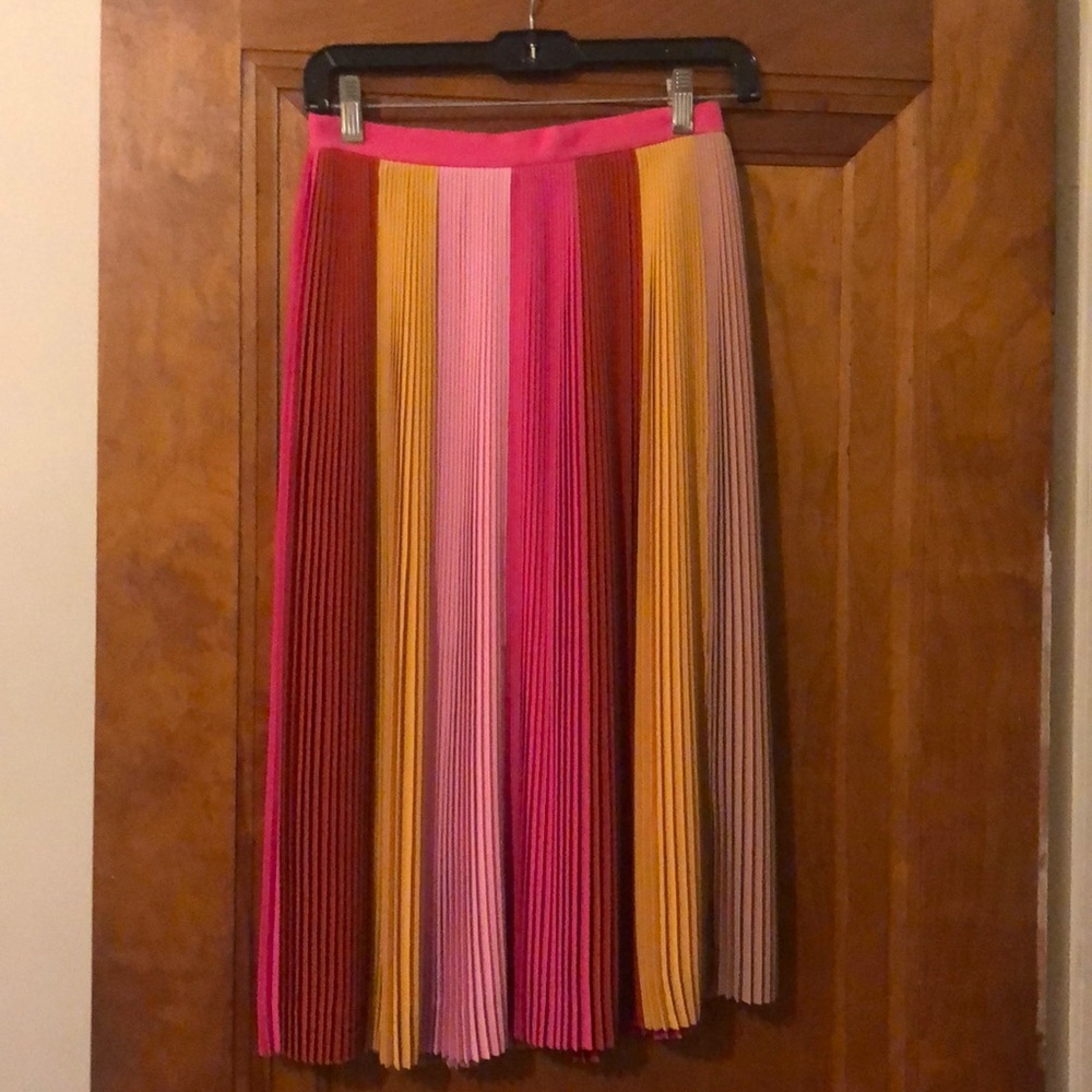 pleated pink, red, and yellow knee-length midi skirt